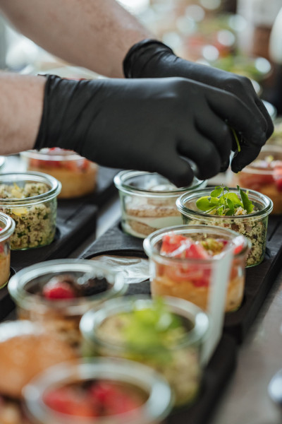 Chef preparing various savory dishes served in glasses