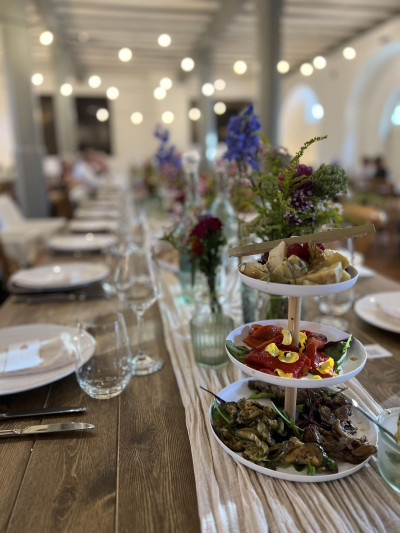 Set table with floral decorations and finger food
